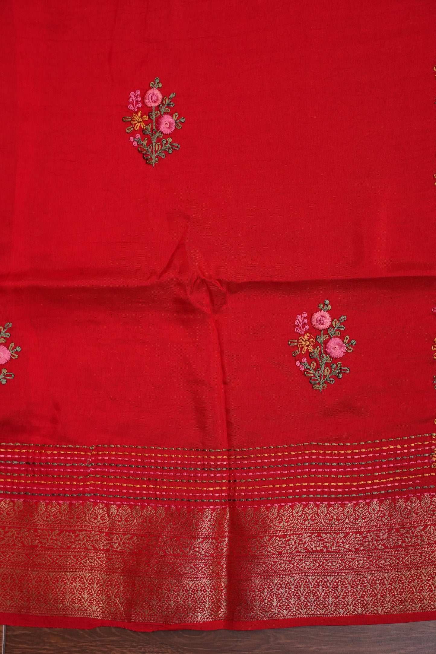 Bright Red Crepe silk saree with French knot work.