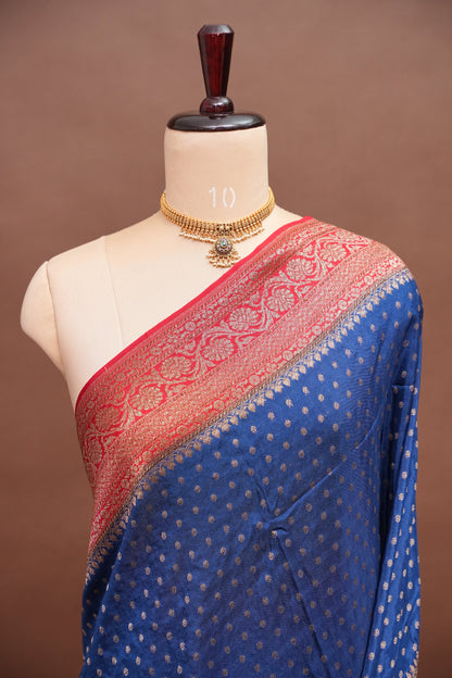 Khaddi Georgette Crepe Silk Saree with Antique Border – Peacock Blue & Red