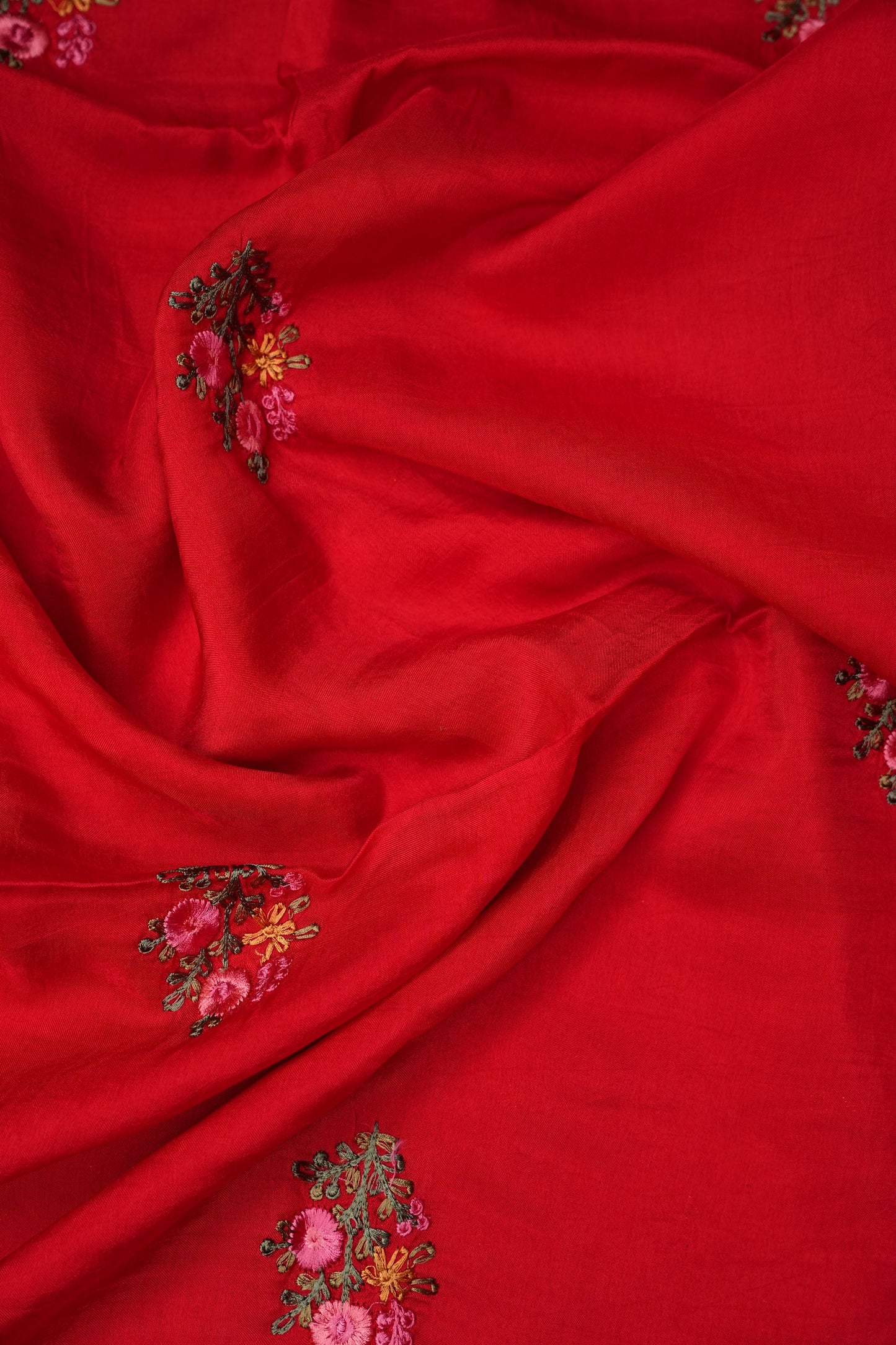 Bright Red Crepe silk saree with French knot work.