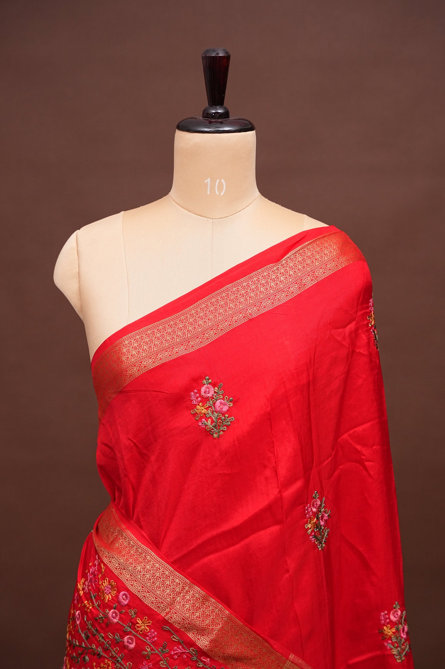 Bright Red Crepe silk saree with French knot work.