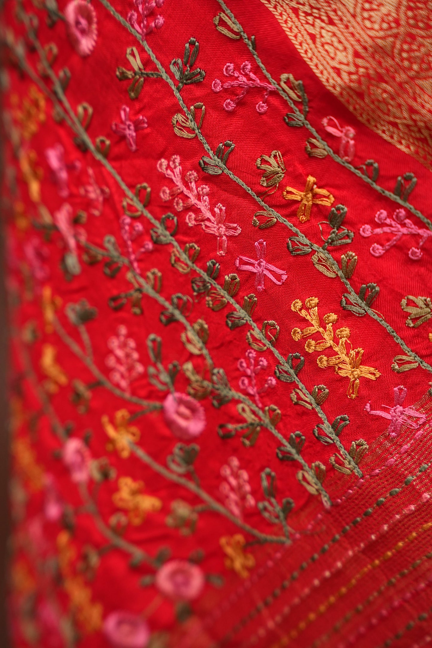 Bright Red Crepe silk saree with French knot work.